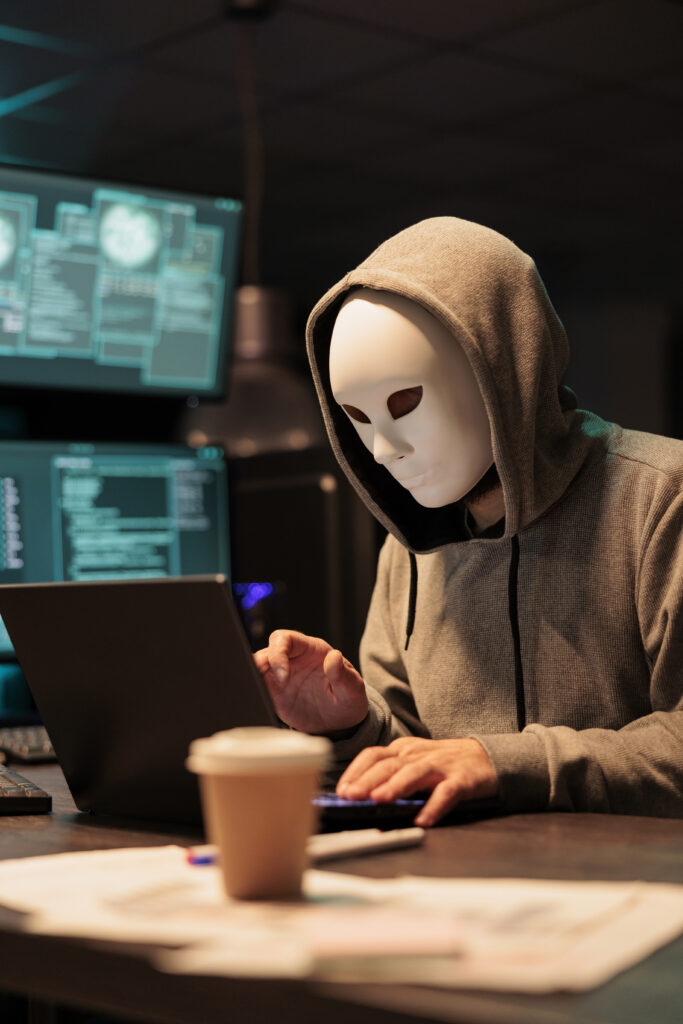 Dangerous masked thief installing virus to hack system